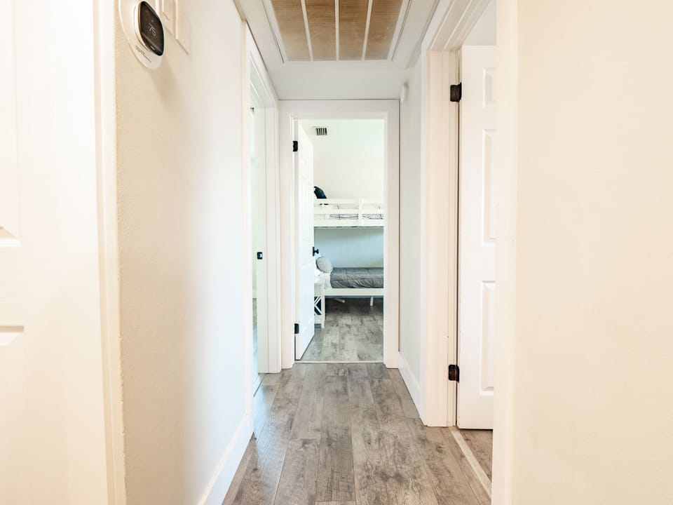 Hallway from kitchen leading to 3 bedrooms.