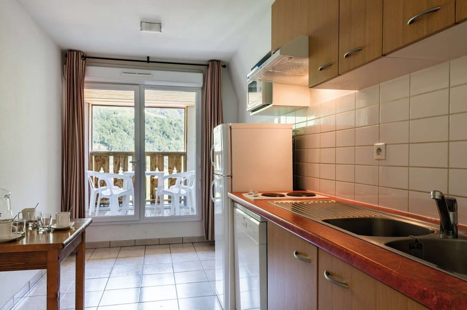 Prepare meals in the small kitchen and enjoy them at the dining table.