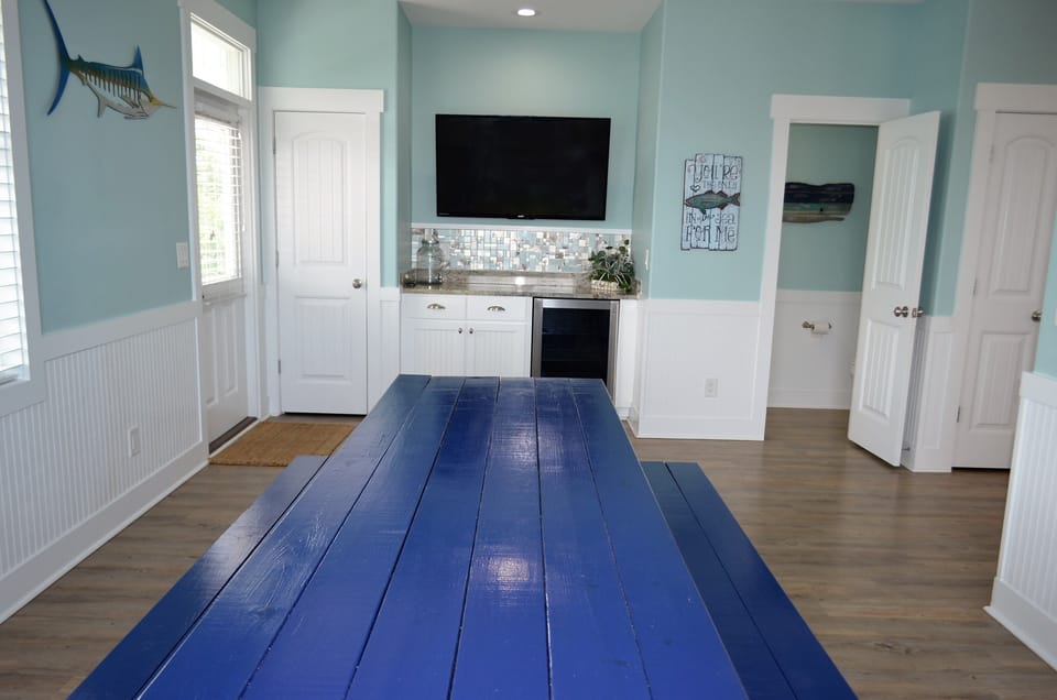 Wine/beverage cooler & large wall mounted flat screen TV.