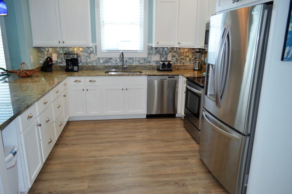 featuring stainless appliances and granite countertops.