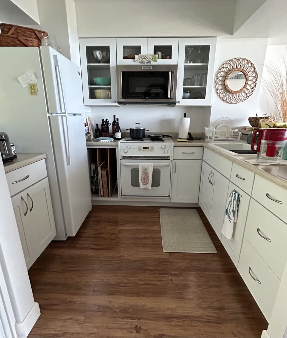 The kitchen with convection microwave and electric stove with oven.
