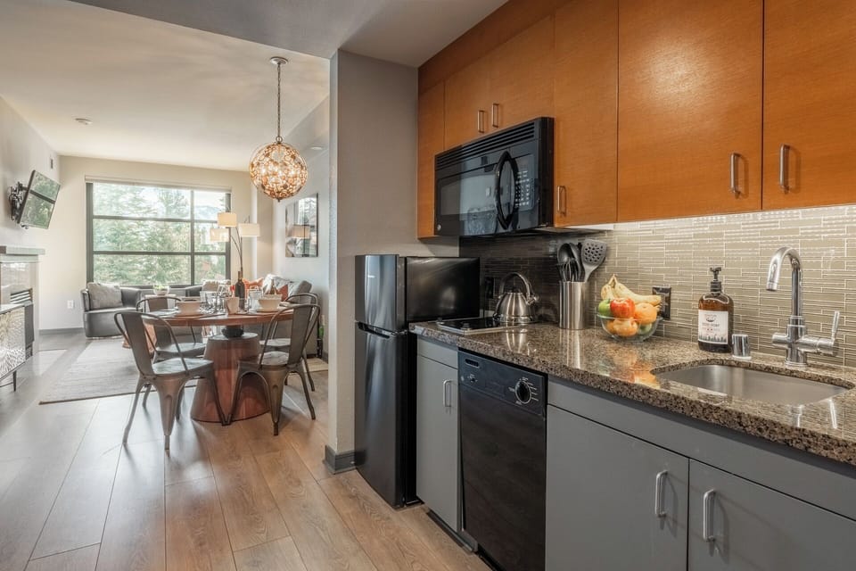 A bright, efficient kitchen is set within the larger living space, making cooking and snacking convenient.