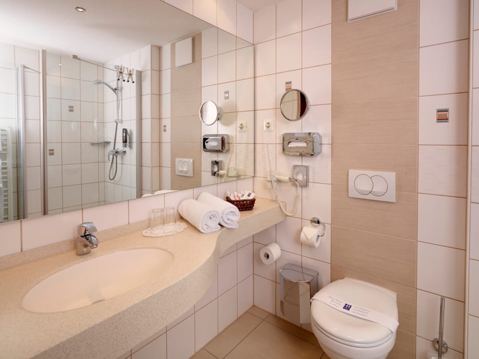 Shower, hair dryer, towels, toilet paper
