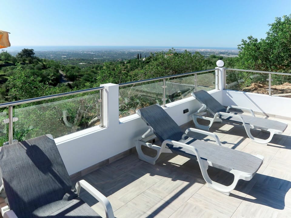 Sky, Plant Community, Shade, Building, Chair, Tree, Outdoor Furniture, Fence, Composite Material, Real Estate
