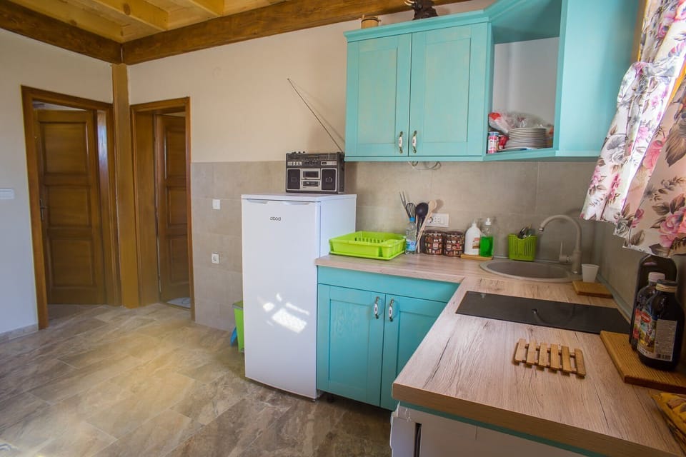 ..with dishwasher, dishes, fridge, trash cant, kettle...