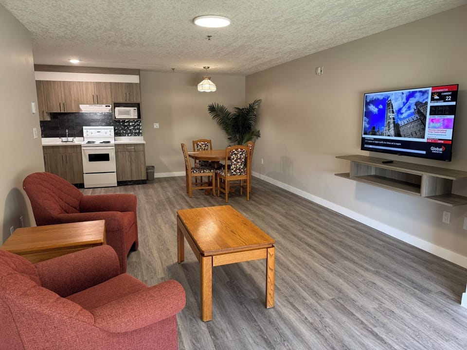 Executive Apartment, 2 Bedrooms, Fireplace (3 Room) | Living area | 55-inch Smart TV with digital channels, fireplace, Netflix