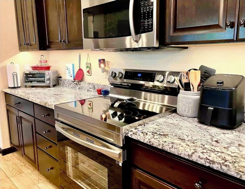 Kitchen equipped with modern conveniences. Microwave, toaster oven, spices, etc.