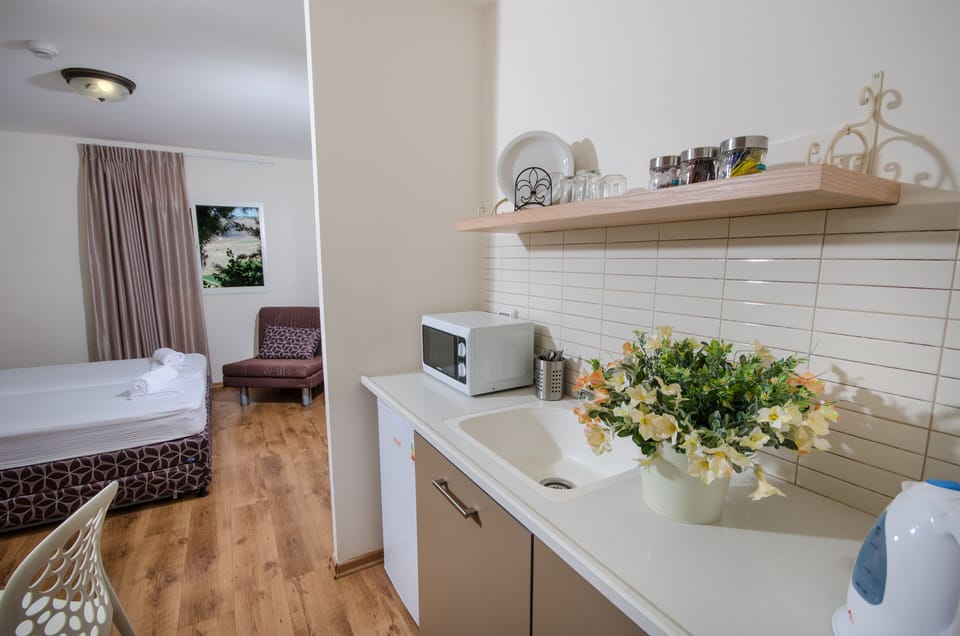 Family Studio with Garden Access | Private kitchen | Microwave, coffee/tea maker, electric kettle