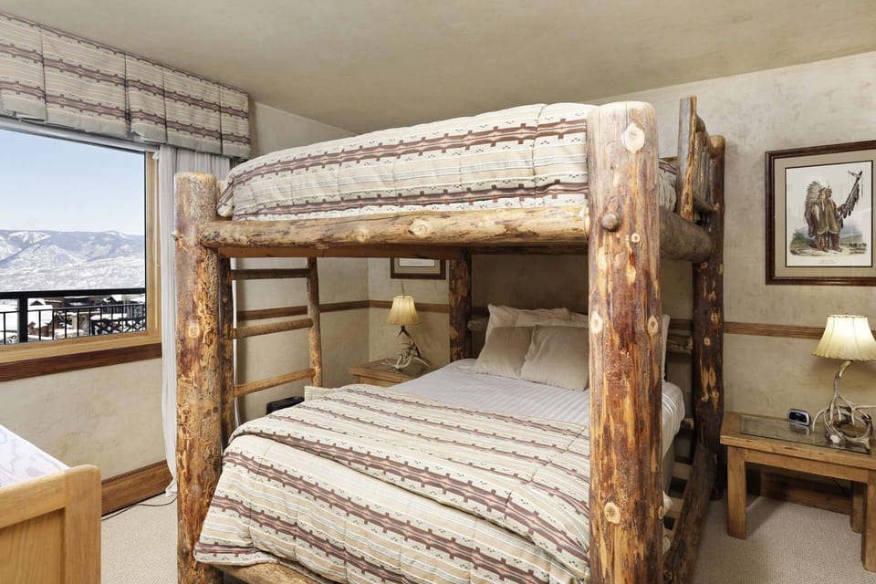 Adults and children will enjoy a great night of sleep in this bedroom with double bunk beds and en-suite bath.