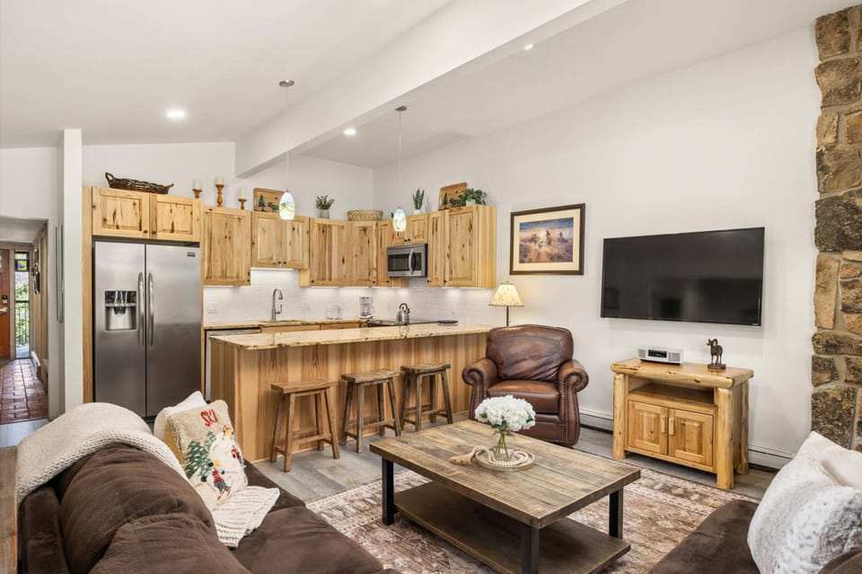 The open concept living and kitchen areas have been beautifully remodeled with natural hickory wood