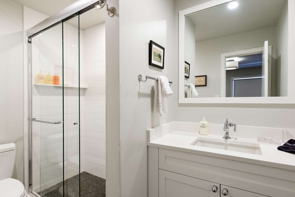 The upstairs twin bedroom has an en-suite bath with walk-in shower.