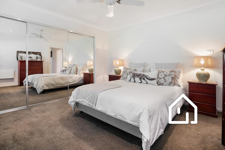 Bedroom 2 with ceiling fan and wall heater