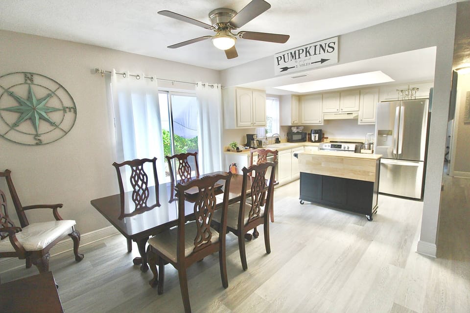 The open dining area, seating 6, leads into the coastal cottage kitchen.