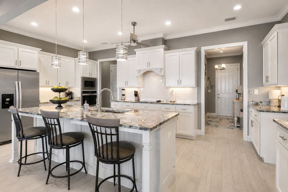 Cook in style in this fully equipped, open-concept kitchen featuring stainless steel appliances, granite countertops, and a large breakfast island. Ideal for family meals and entertaining with Gulf breezes nearby.
