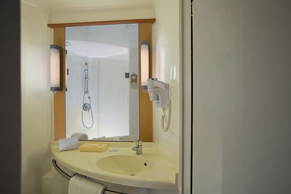 Shower, eco-friendly toiletries, hair dryer, slippers