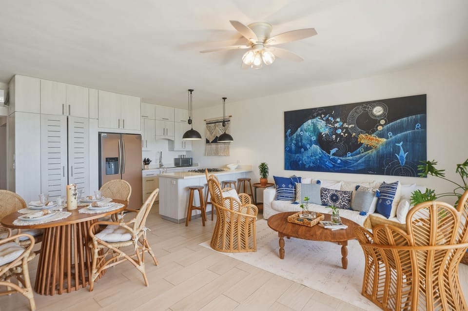 An open-concept living room and kitchen where everyone stays connected. Bright, airy, and perfect for gathering after a day at the beach.