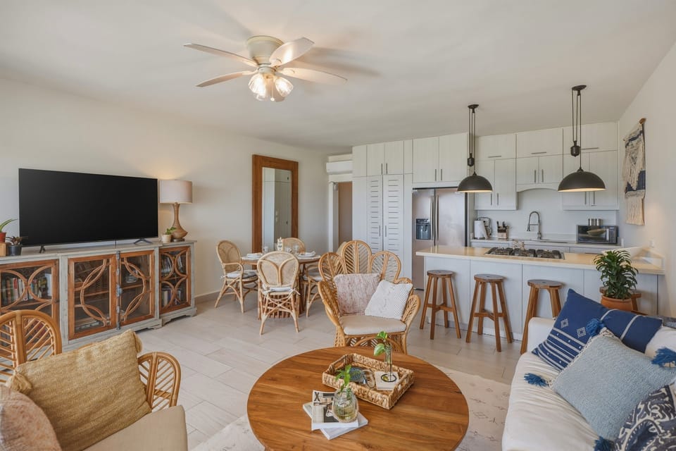 A cool, comfortable living room with TV and air conditioning. Perfect for relaxing indoors while still feeling connected to the ocean outside.
