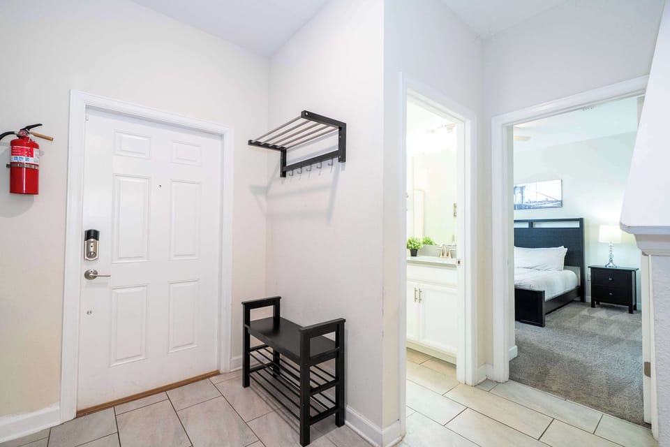 Welcome home! This stylish entryway with a handy bench and hooks greets you with modern simplicity-just steps from the inviting king-sized bedroom.