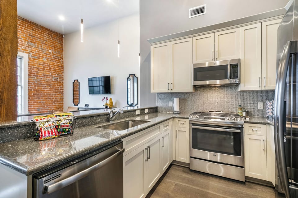 Cook and dine easily in the fully stocked kitchen, equipped with all stainless steel appliances, gas range, basic cookware, and a dining area for a comfortable meal at home. Entertain at the bar with seating for four.