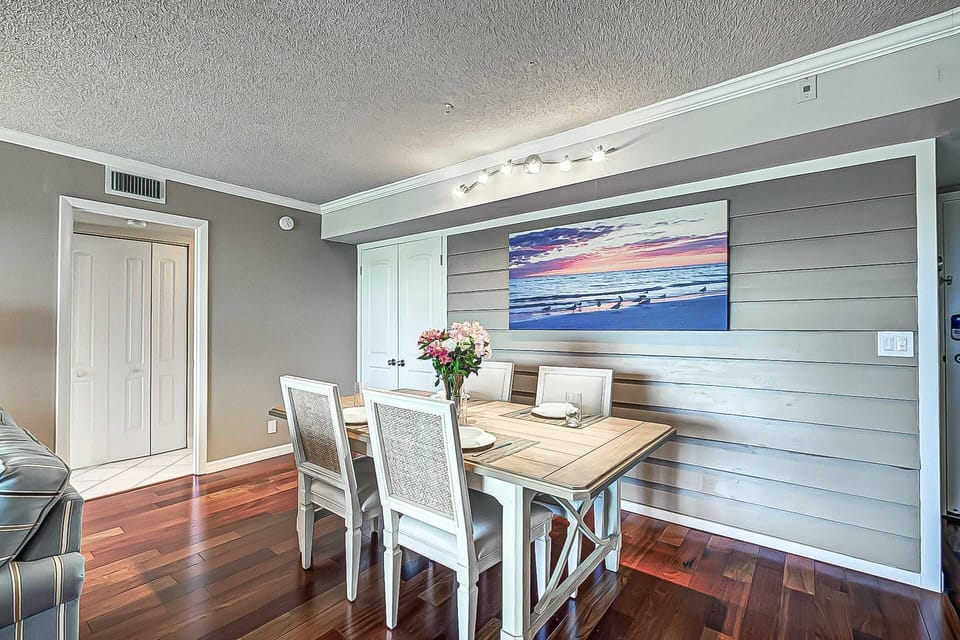The dining table seats 6 adults comfortably and is near the kitchen.  Laundry closet on  the left.