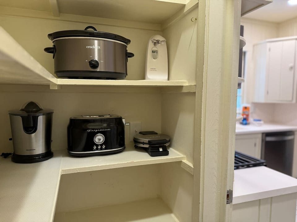 Stocked and ready for your culinary creations! Our pantry features all the essentials: a crockpot, can opener, electric juicer, toaster, and waffle maker—perfect for making your stay feel like home.