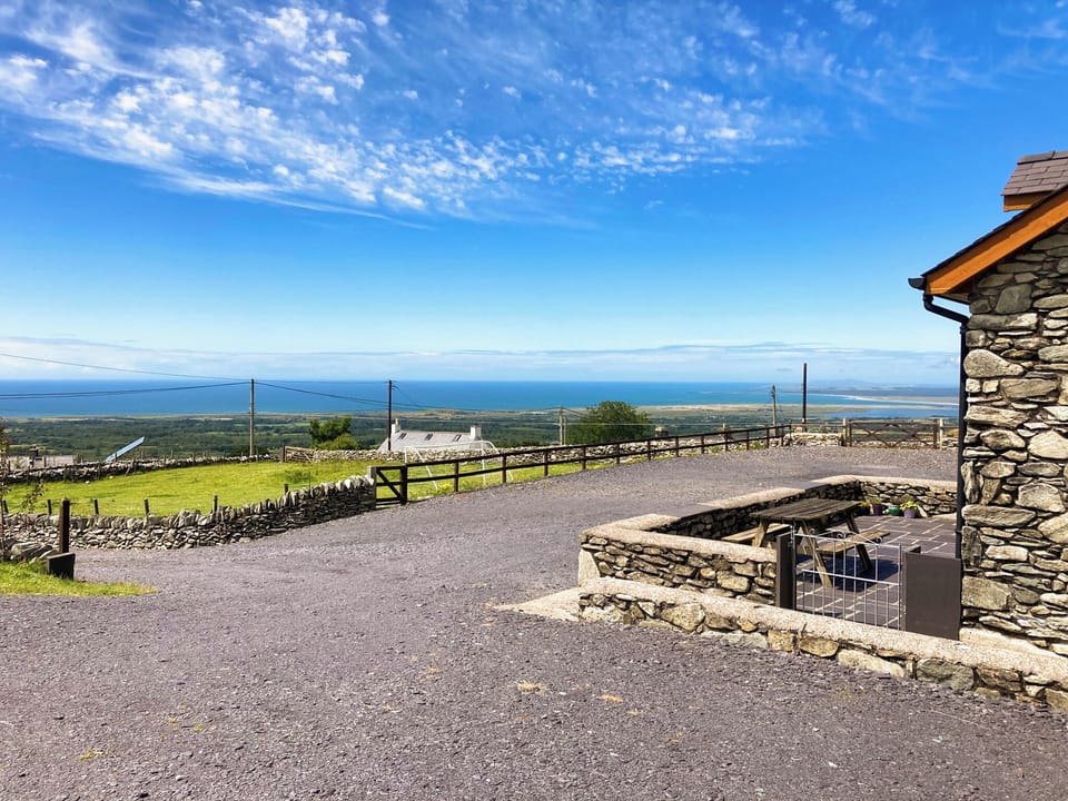 The outlook from the outside of Beudy Bach looking towards Caernarfon Bay and Ireland in the distance | Beudy Bach, Cilgwyn, near Caernarfon