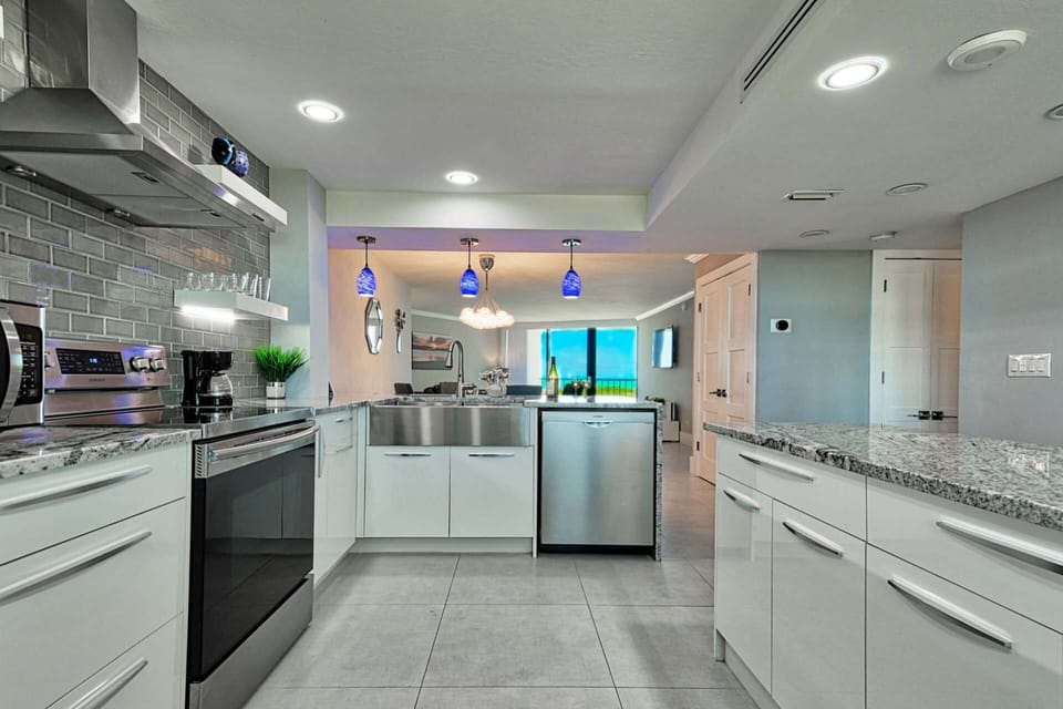 Enjoy the beautiful scenery indoors and outdoors as you cook a meal in this stunning kitchen.