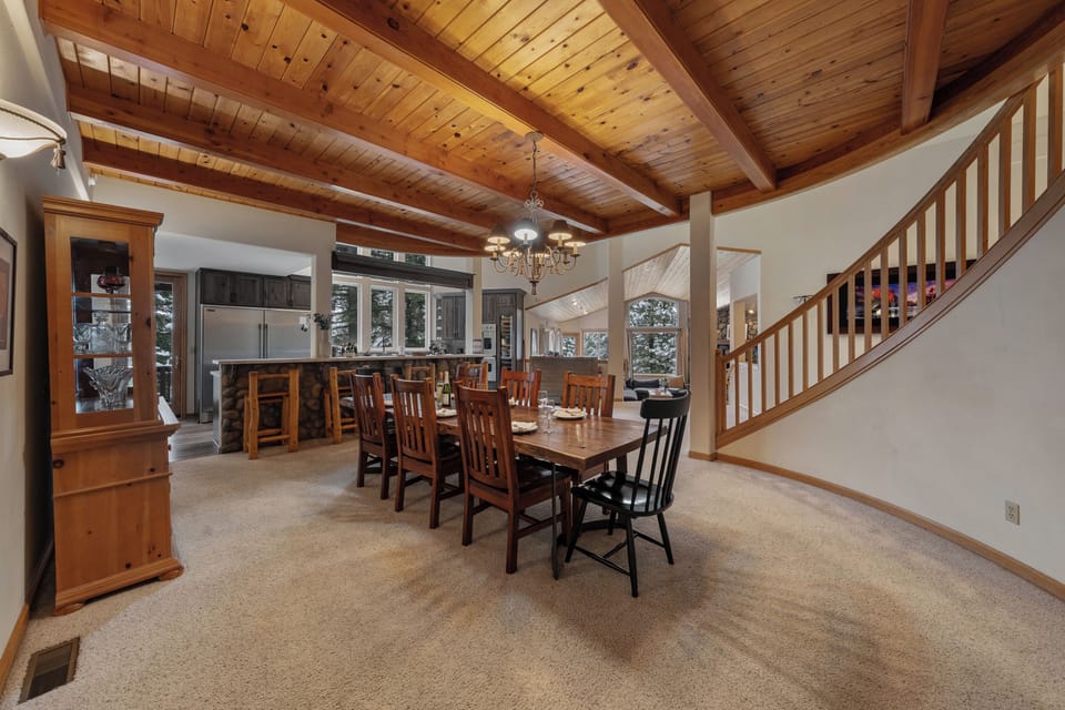 Large dining table under warm wood ceilings, perfect for group meals.