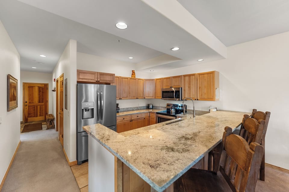 Your fully equipped kitchen features granite countertops, stainless steel appliances, and a spacious island perfect for cooking memorable meals together.
