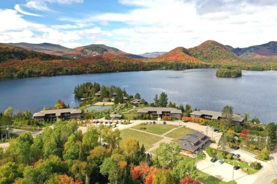 Serene lake view featuring a charming resort and canoe—perfect for peaceful water activities and relaxation.