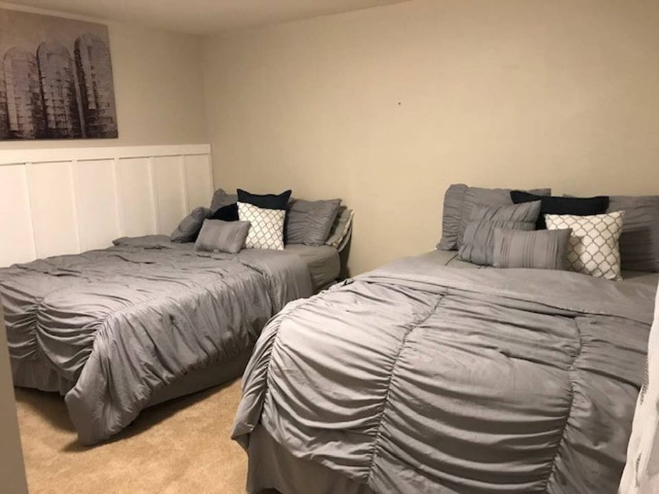 bottom level bedroom with 2 queen beds