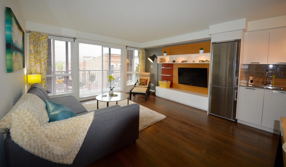 Broad view of the open-concept footprint showcasing sightlines from the entryway straight through to the balcony.
