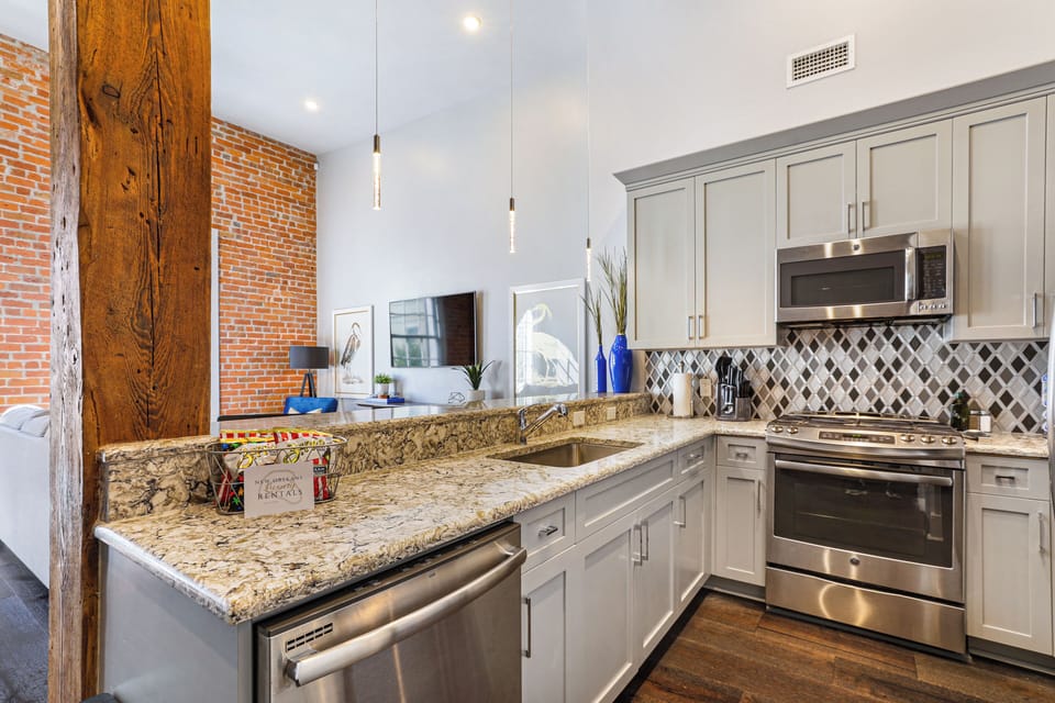 Cook and dine easily in the fully stocked kitchen, equipped with all stainless steel appliances, gas range, basic cookware, and a dining area for a comfortable meal at home. Entertain at the bar with seating for four.