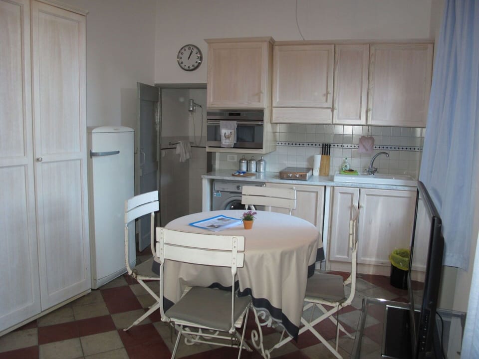 Cabinetry, Furniture, Countertop, Table, Kitchen, Kitchen Appliance, Wood, Interior Design, Clock, Refrigerator