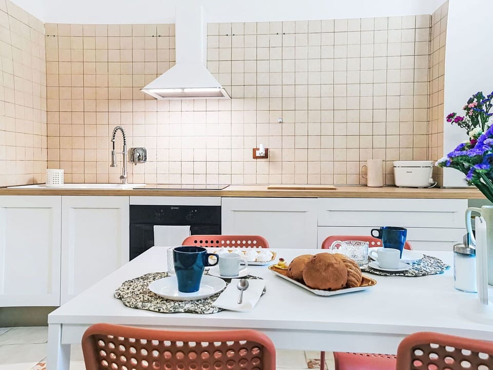 Furniture, Interior Design, Kitchen, Flooring, Countertop, Kitchen Appliance, Floor, Lighting, Room, Cabinetry