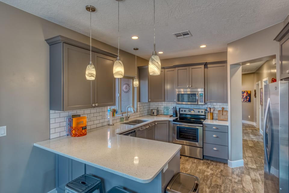 Fully stocked kitchen with pots, pans, blender, toaster, coffee maker and more