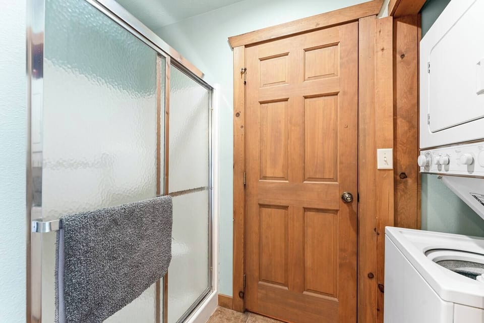 Master bath #2 with standalone shower unit and washer and dryer