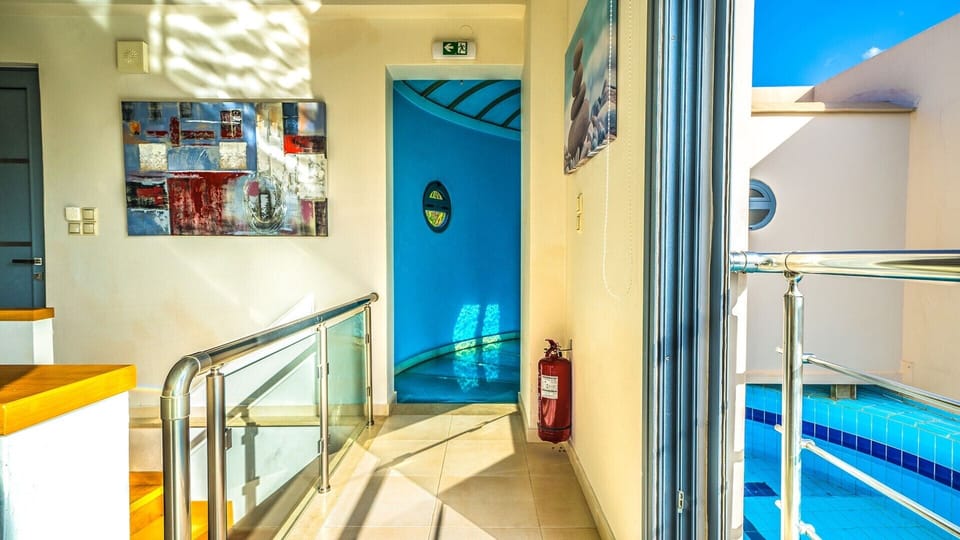 An impressive glass corridor is placed over the pool, leading to the bedrooms.