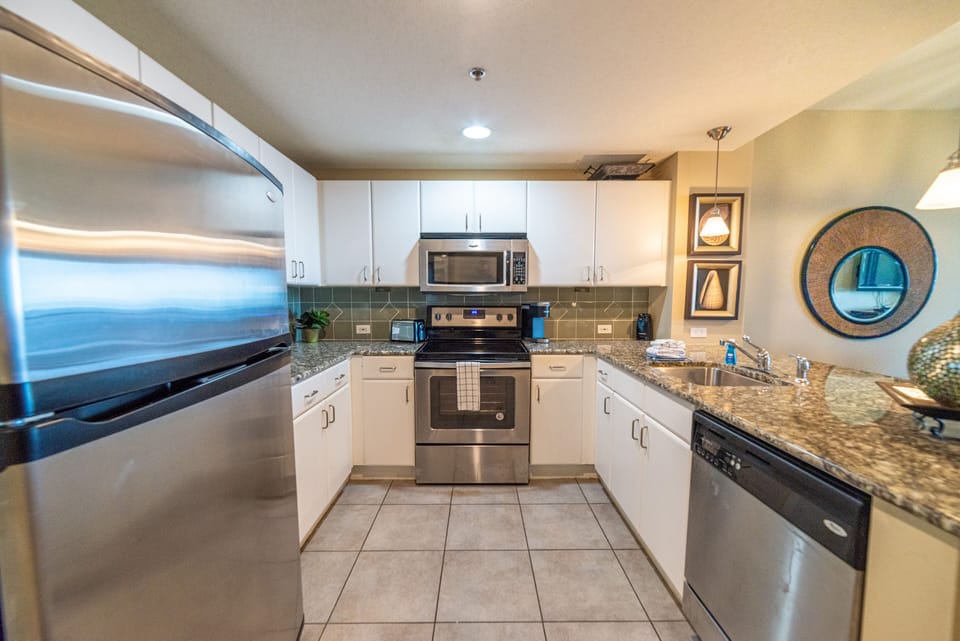 The kitchen offers stainless steel appliances, granite counters, and up-to-date cabinetry