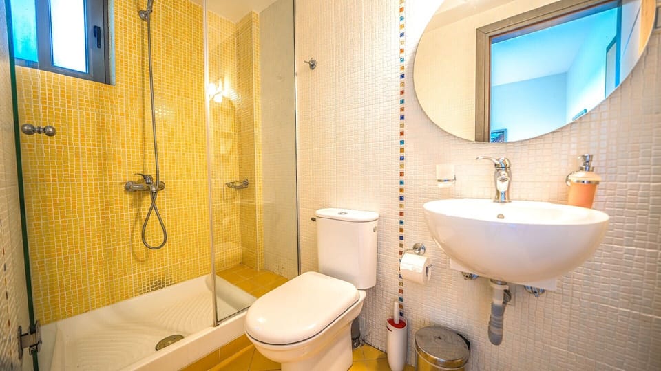 The WC with shower in the living room of the villa.