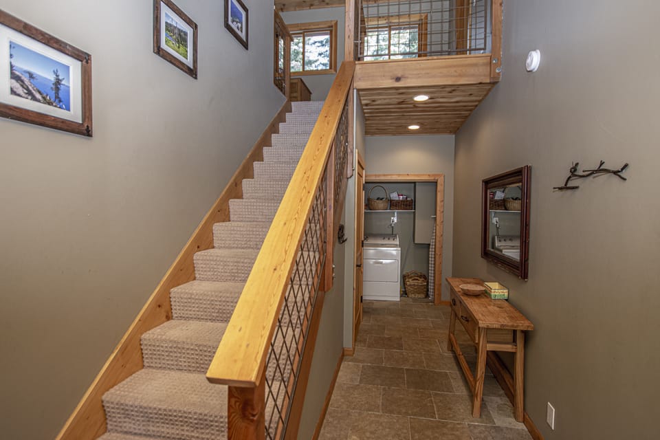 Bonanza Stairs Laundry - Staircase landing w/ wood railing leading to upper level rooms