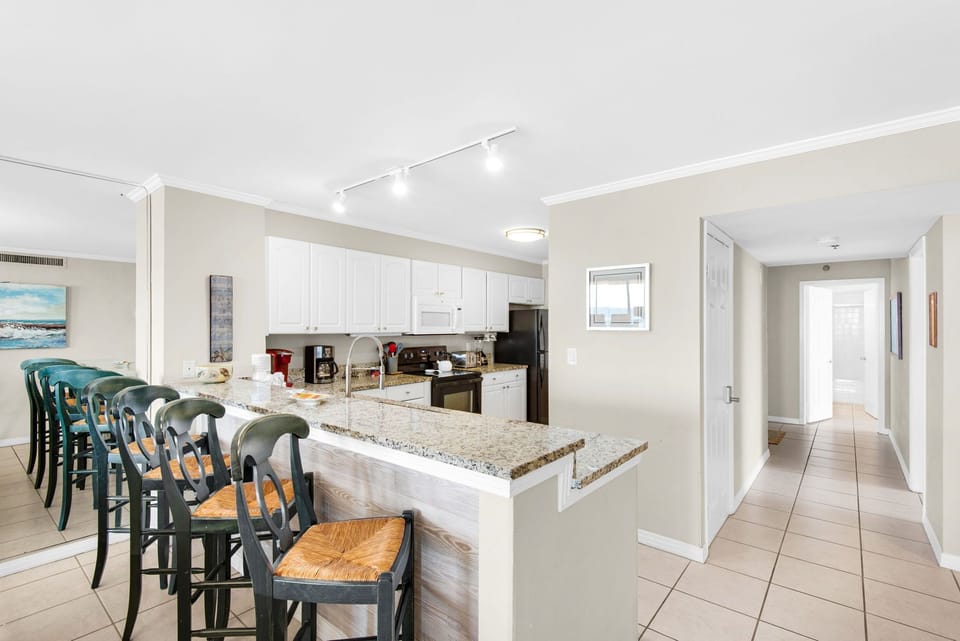 Your spacious kitchen features granite countertops, modern appliances, and a breakfast bar perfect for casual meals and morning coffee.