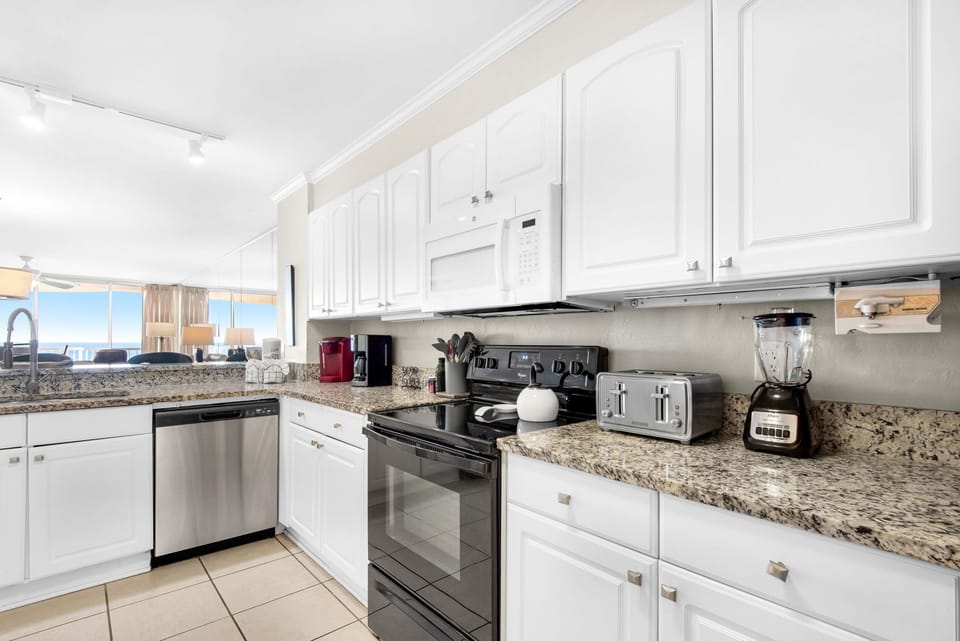 Your fully equipped kitchen features granite counters, stainless appliances, and ocean views—perfect for preparing meals while enjoying the scenery.