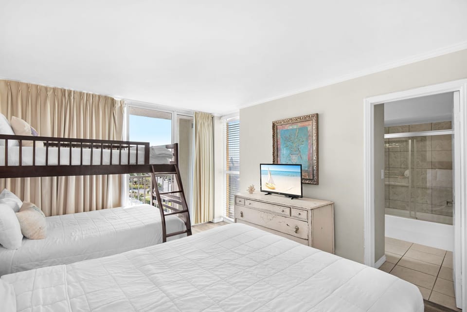 Your spacious family room features comfortable beds plus fun bunk beds, with your own TV and bright windows overlooking the area.