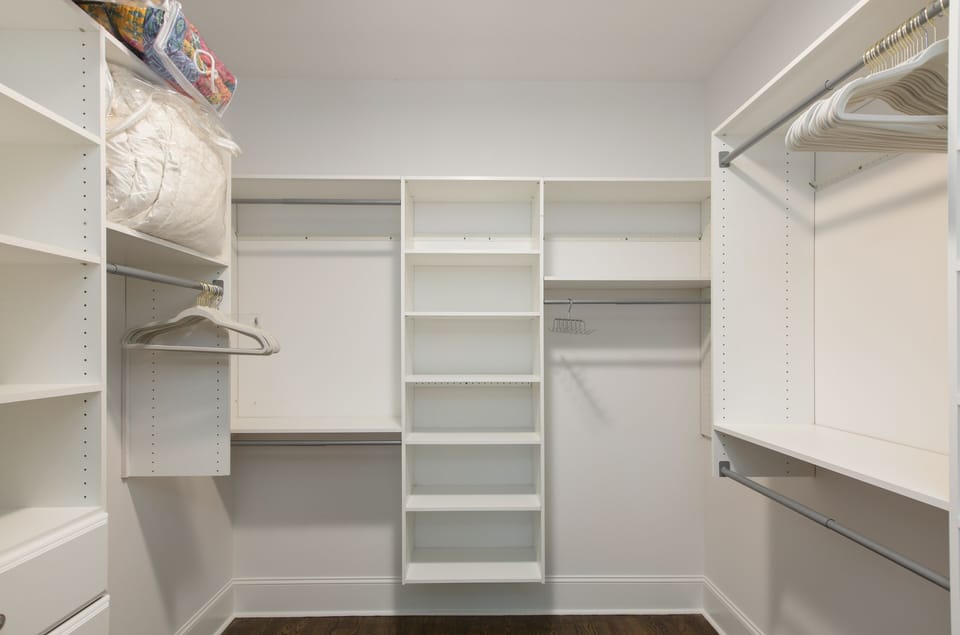 huge walk-in closet in master bedroom with closet system