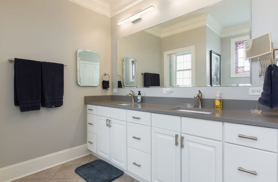 ensuite bathroom with double vanity on main level