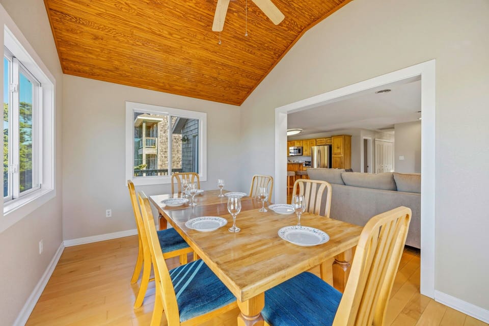 Gather around this charming dining table where your group can share memorable meals beneath the warmth of stunning wood beam ceilings.