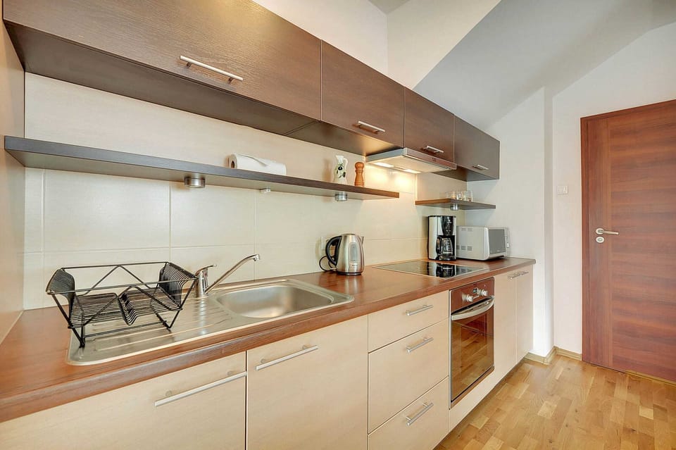 Kitchenette with oven and refrigerator. 