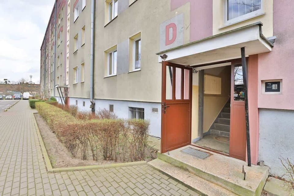 The building is surrounded by green spaces and parks, perfect for outdoor activities.