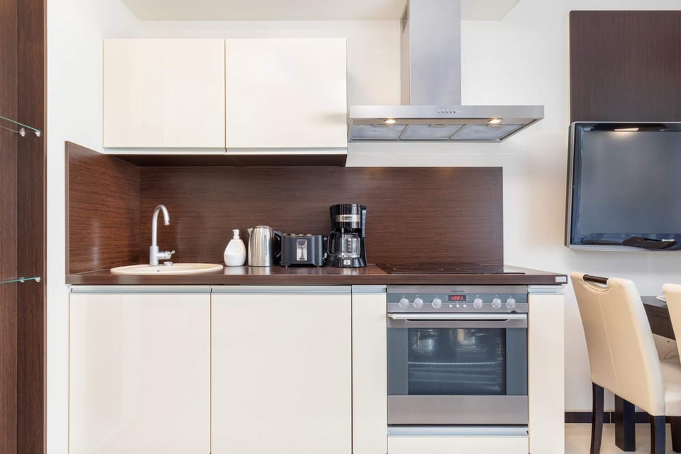Kitchenette with oven and refrigerator. 